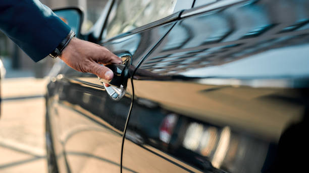 Professional chauffeur opening door for luxury limo service near me in Avondale.