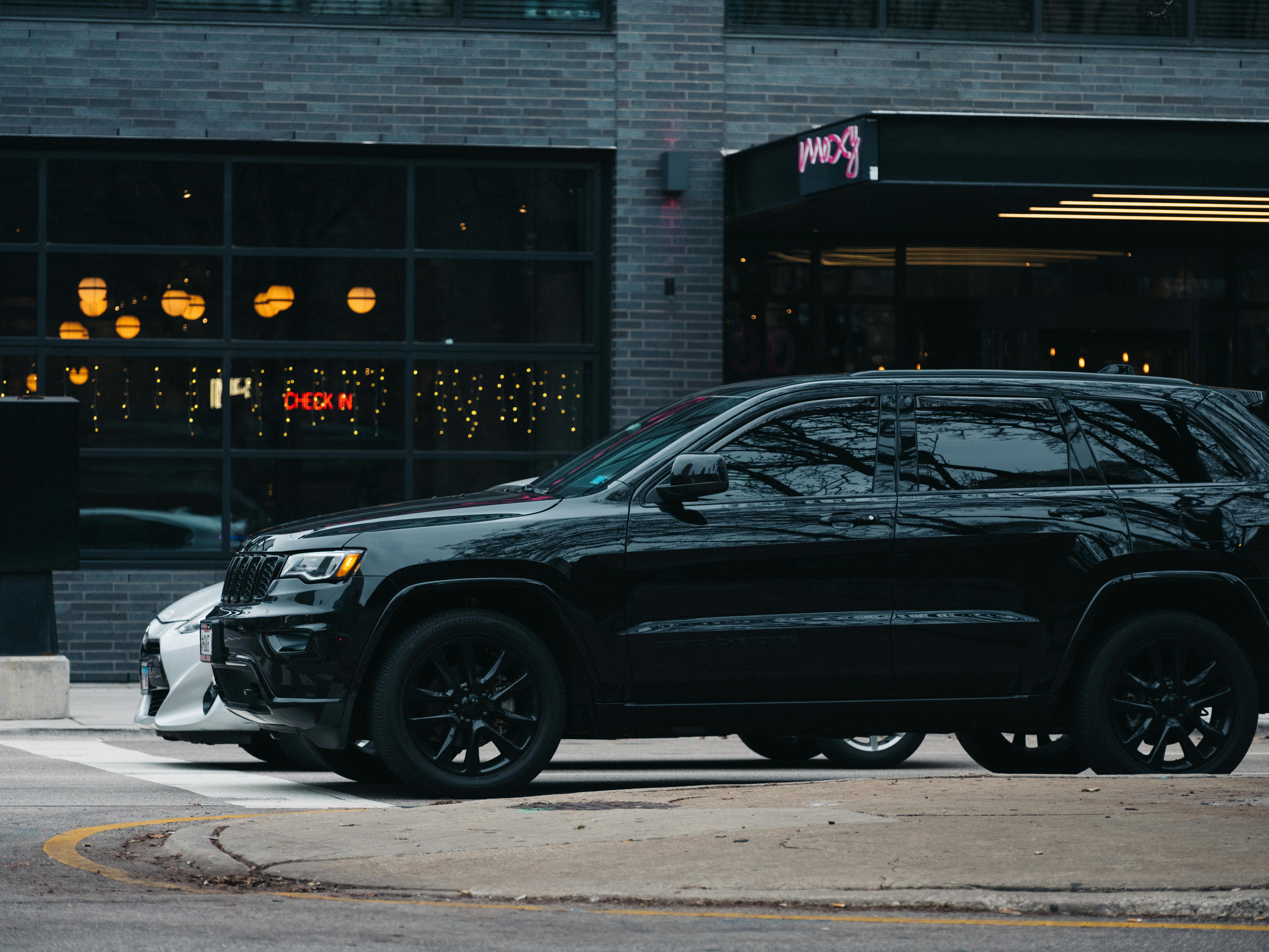 A black luxury SUV parked on a city street, representing professional Fountain Hills Limo Service.